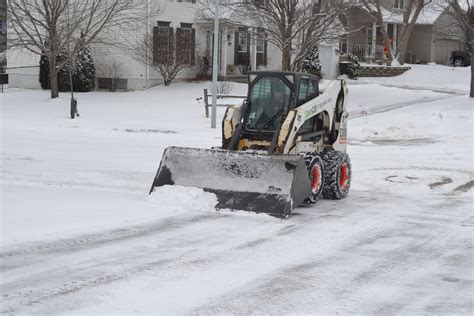 pushing snow with a bobcat 310 skid steer|bobcat skid loader plowing.